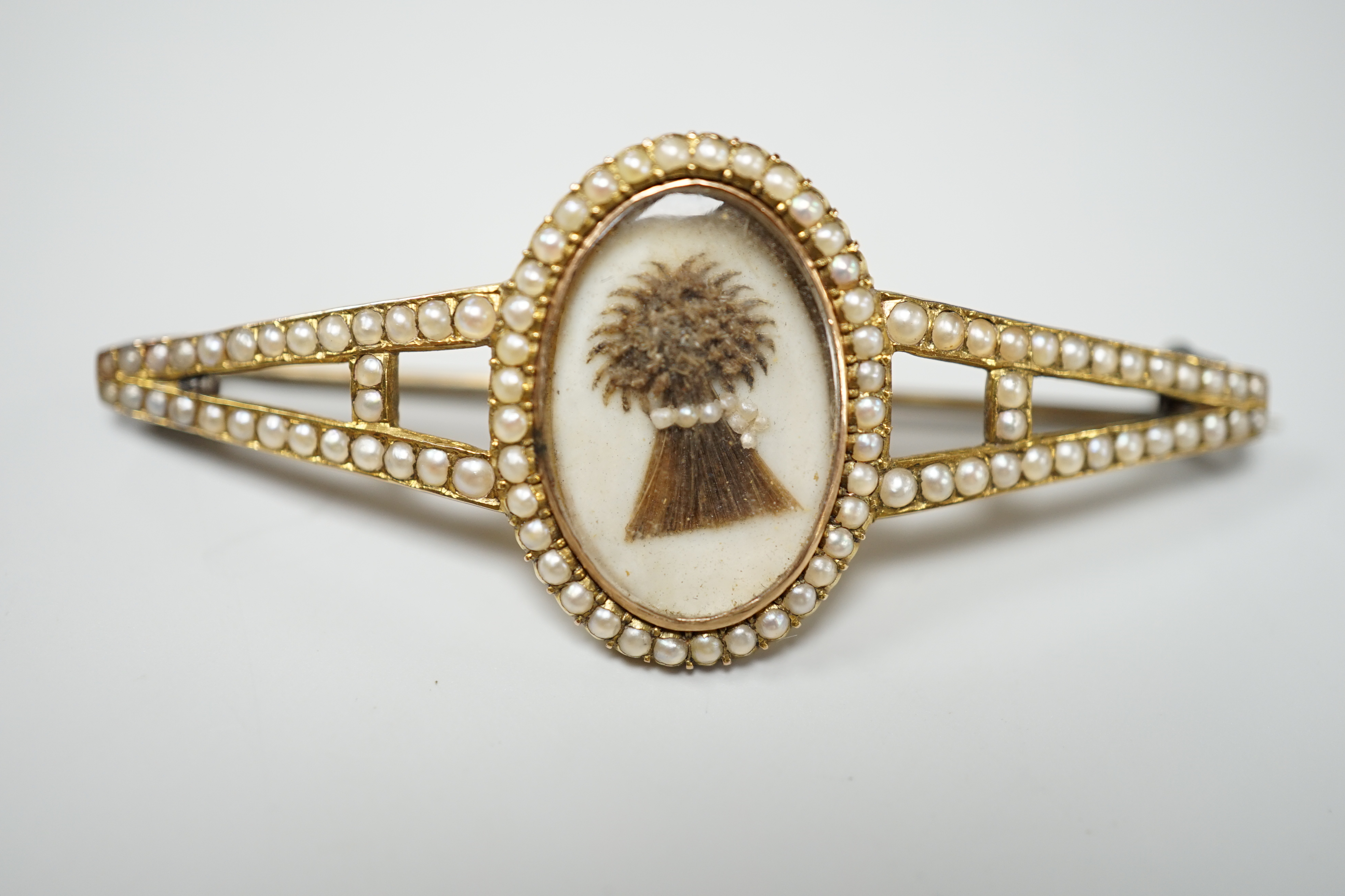 A Regency split pearl set gold brooch, inset with a hairwork bushel of wheat, 5.25cm